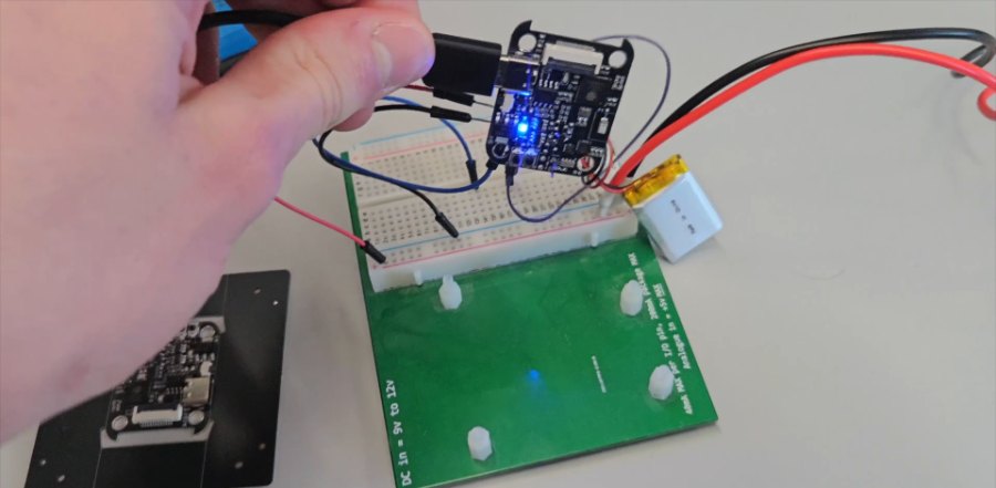 The board powered on, with the battery attached