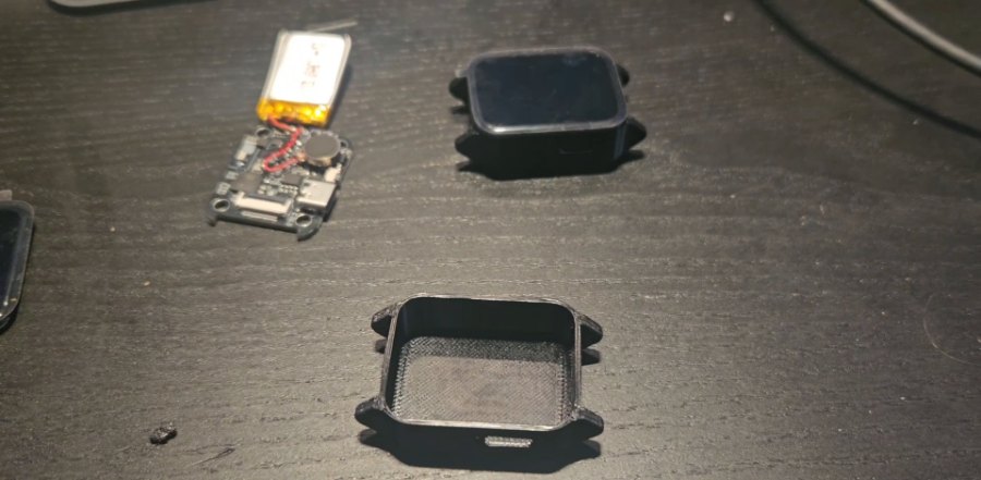 Board, battery and case laid out before assembly